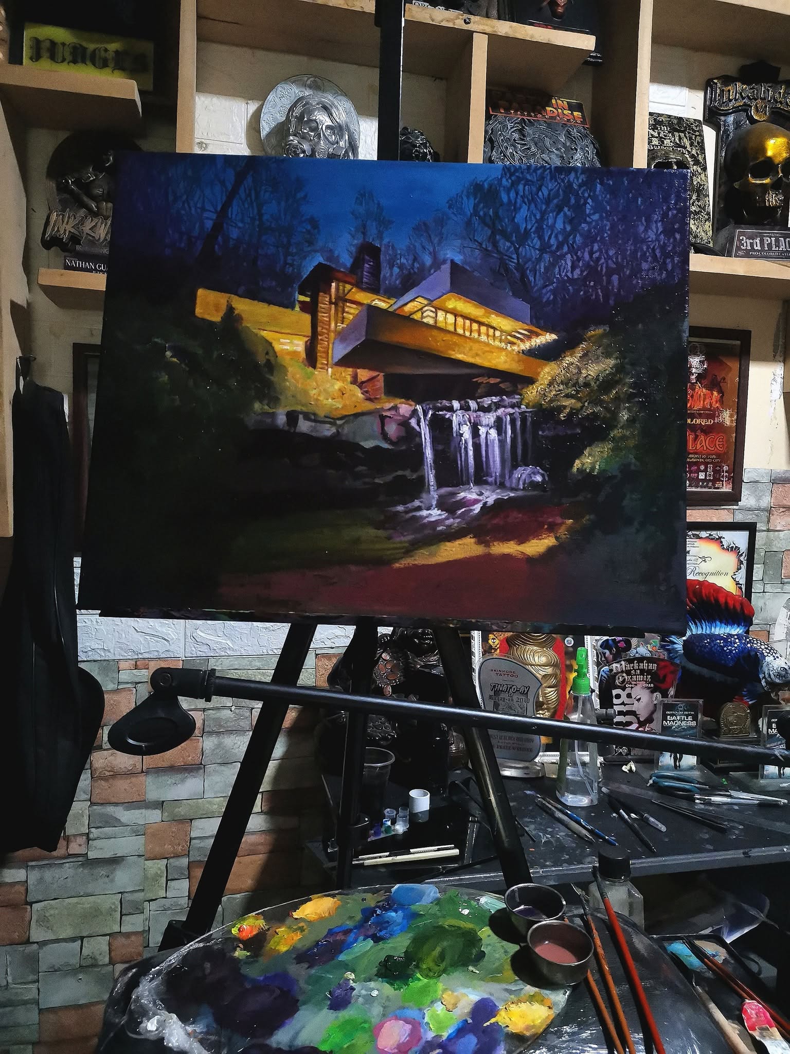 Oil painting of a lit house above a waterfall at night