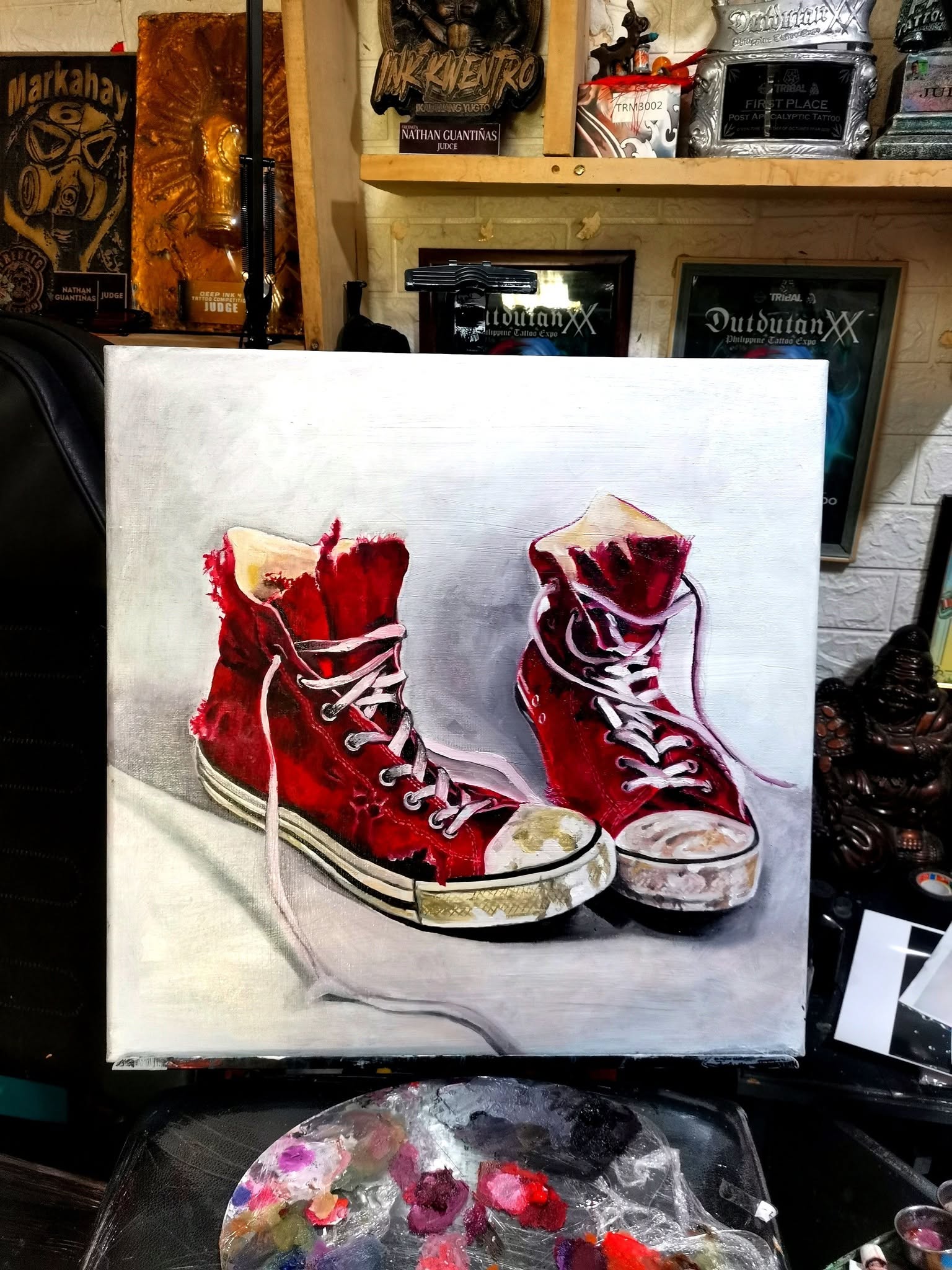 Oil painting of worn red canvas sneakers