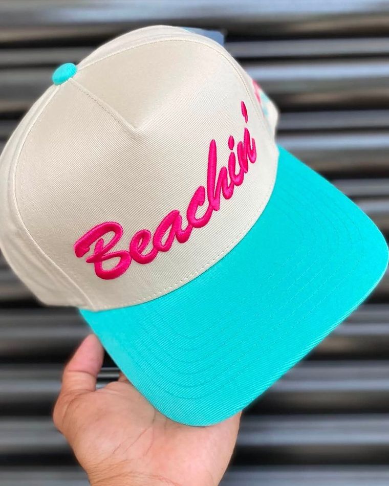 Cream cap with a teal brim