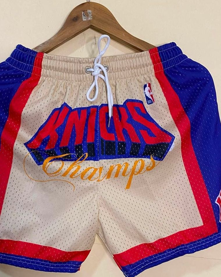 Cream mesh shorts with blue side panels and red trim