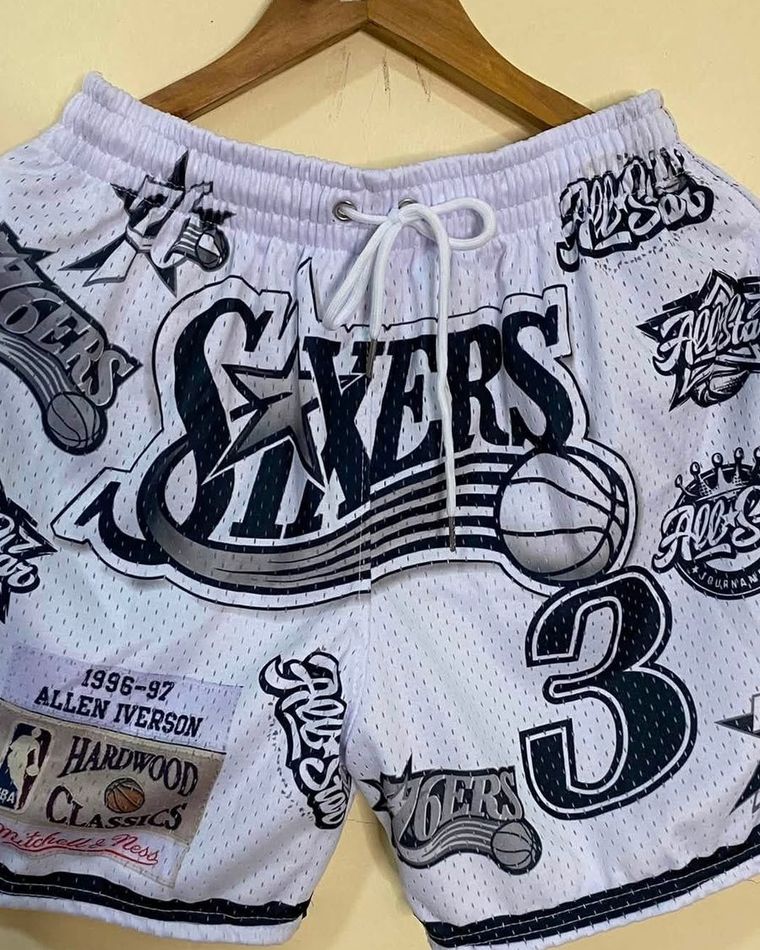 White mesh shorts covered in patch-style prints